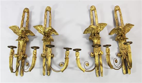 A set of four French Empire style carved giltwood wall lights, L.2ft 5in.